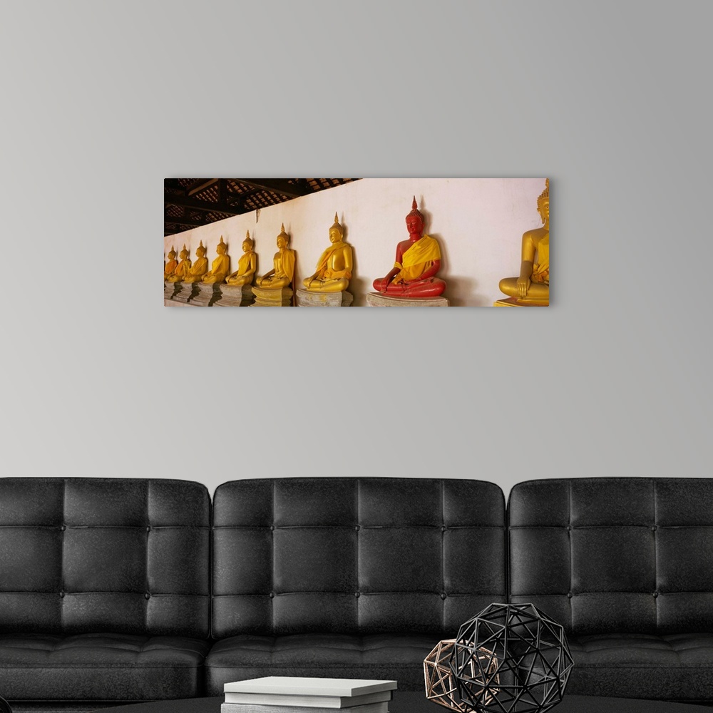 A modern room featuring Statues of Buddha in a temple, Wat Phutthaisawan, Ayuthaya, Thailand