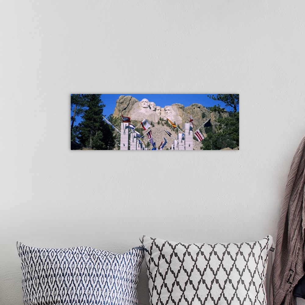 A bohemian room featuring Panoramic photograph of iconic stone memorial carved in mountainside with column and flag lined w...