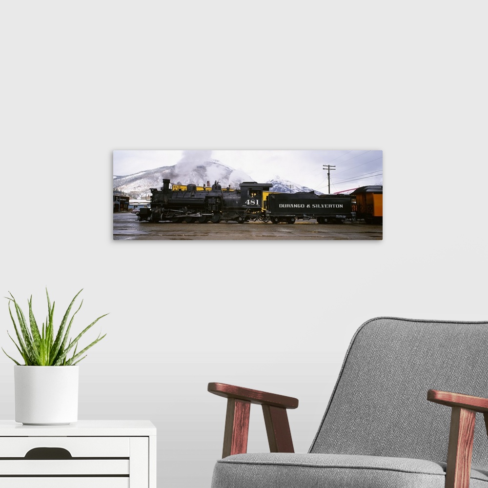 A modern room featuring Oversized, horizontal photograph of a steam powered train and cars at the Durango and Silverton N...