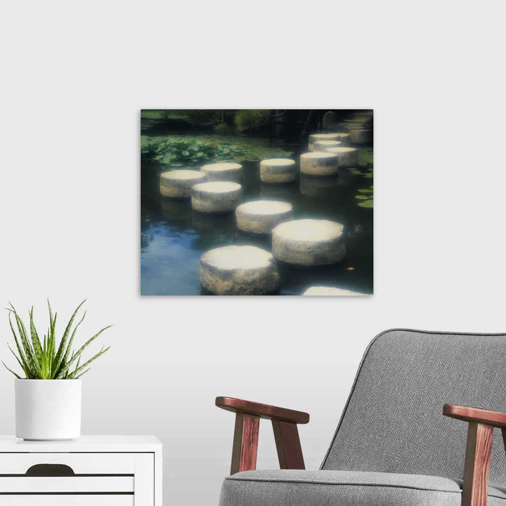 A modern room featuring Large photo of a walkway of rocks across the water in a Japanese garden in Kyoto, Japan.