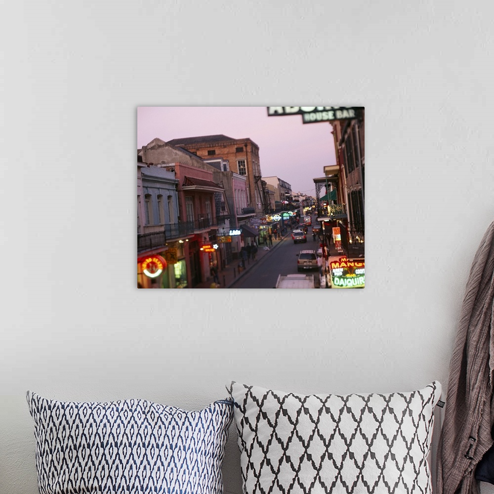 A bohemian room featuring Landscape, large photograph looking down Bourbon Street in New Orleans, Louisiana.  Rows of store...