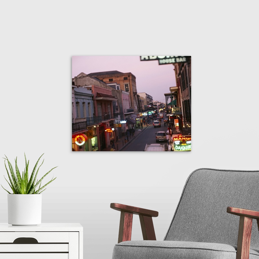 A modern room featuring Landscape, large photograph looking down Bourbon Street in New Orleans, Louisiana.  Rows of store...