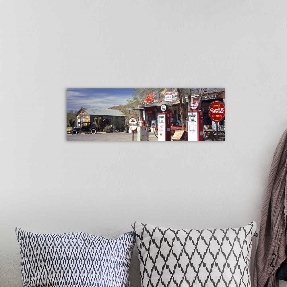 A bohemian room featuring Long panoramic photo on canvas of a vintage Route 66 gas station with an old car outside.