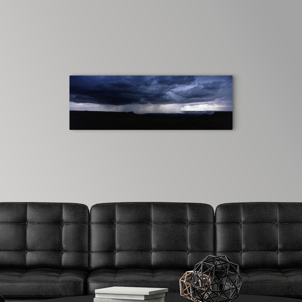 A modern room featuring A wide angle shot taken of an immense storm over canyons in Utah.
