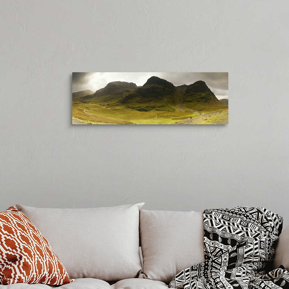 A bohemian room featuring Storm clouds over a mountain range, Three Sisters of Glen Coe, Scotland