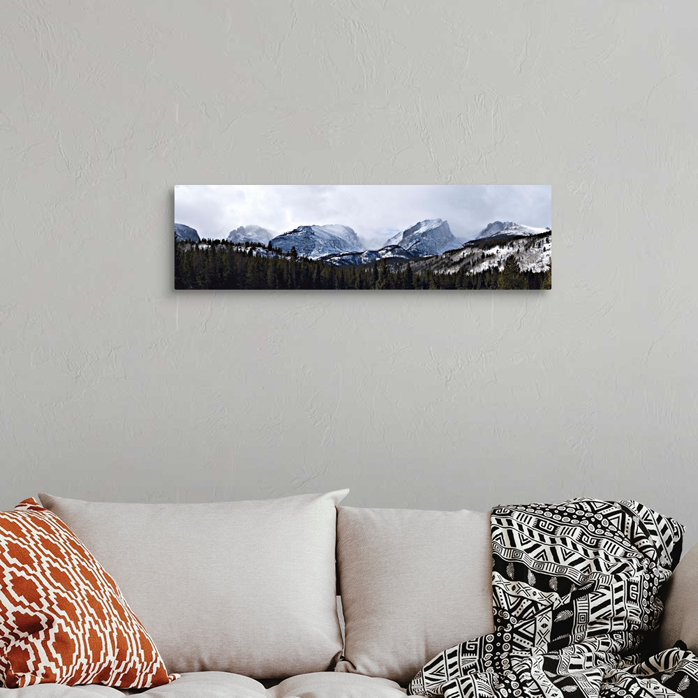 A bohemian room featuring Storm clouds over snow covered mountains, Rocky Mountain National Park, Colorado,