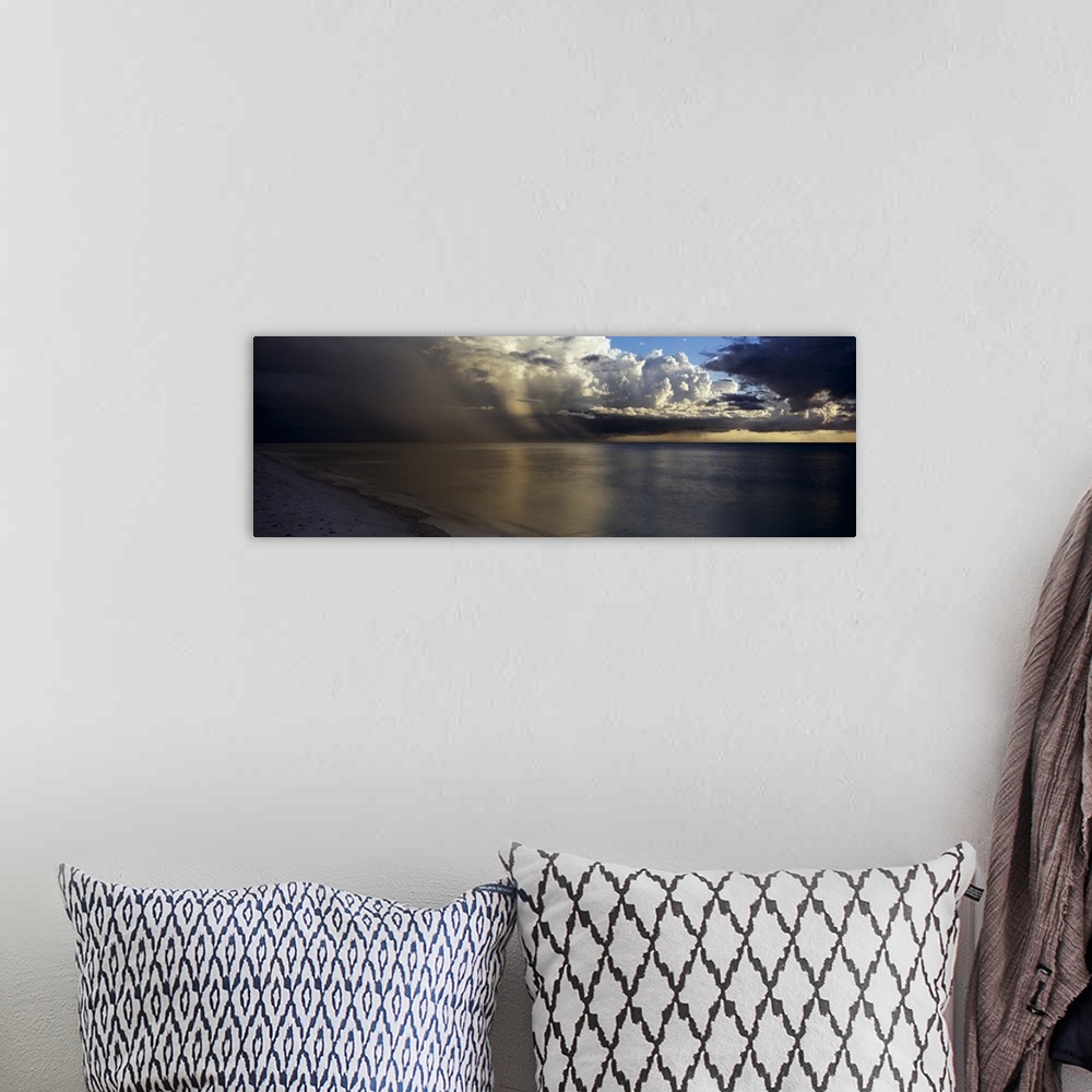 A bohemian room featuring This is a panoramic photograph of clouds accumulating off shore before sunset.