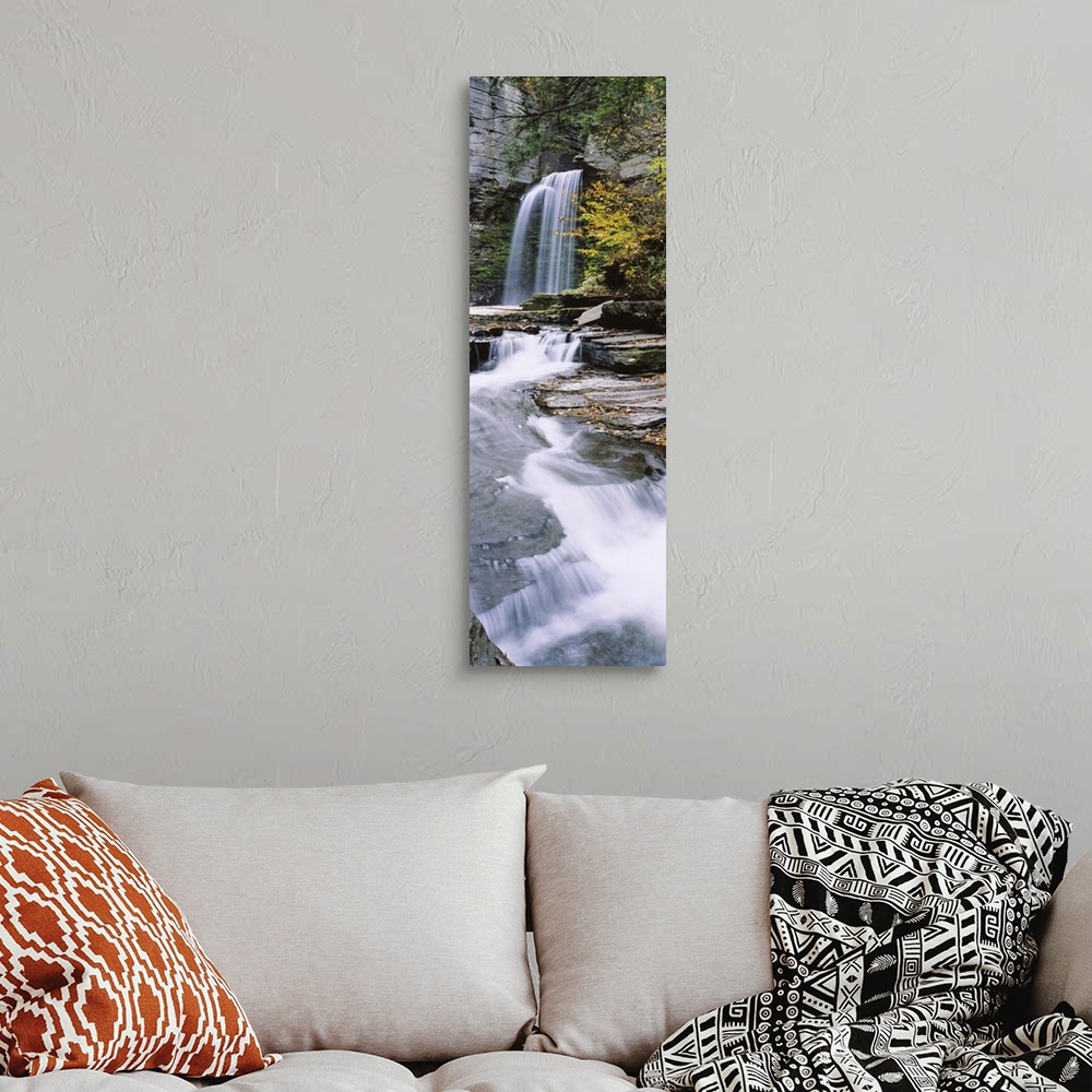 A bohemian room featuring A continuous cascade of water down flat rocky surfaces captured in a time lapsed photograph in th...