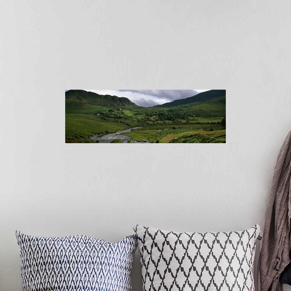 A bohemian room featuring Stream through lush mountain landscape, distant cottages, Ireland