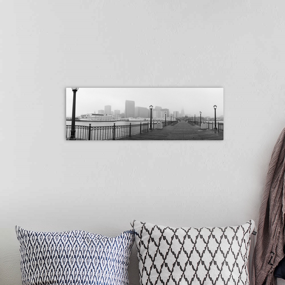 A bohemian room featuring Black-and-white panoramic photo of an empty San Francisco pier on a foggy day in California.