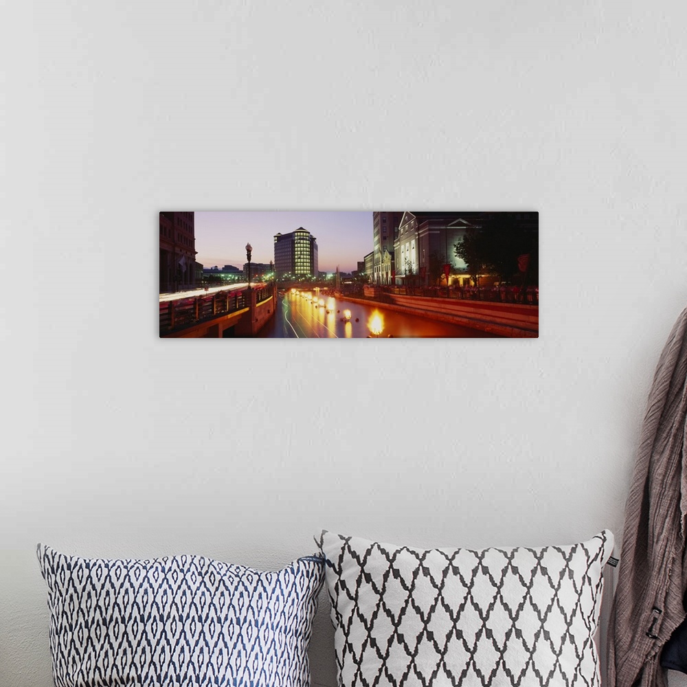 A bohemian room featuring Panoramic canvas photo of lights along a road that leads to buildings in a city at sunset.