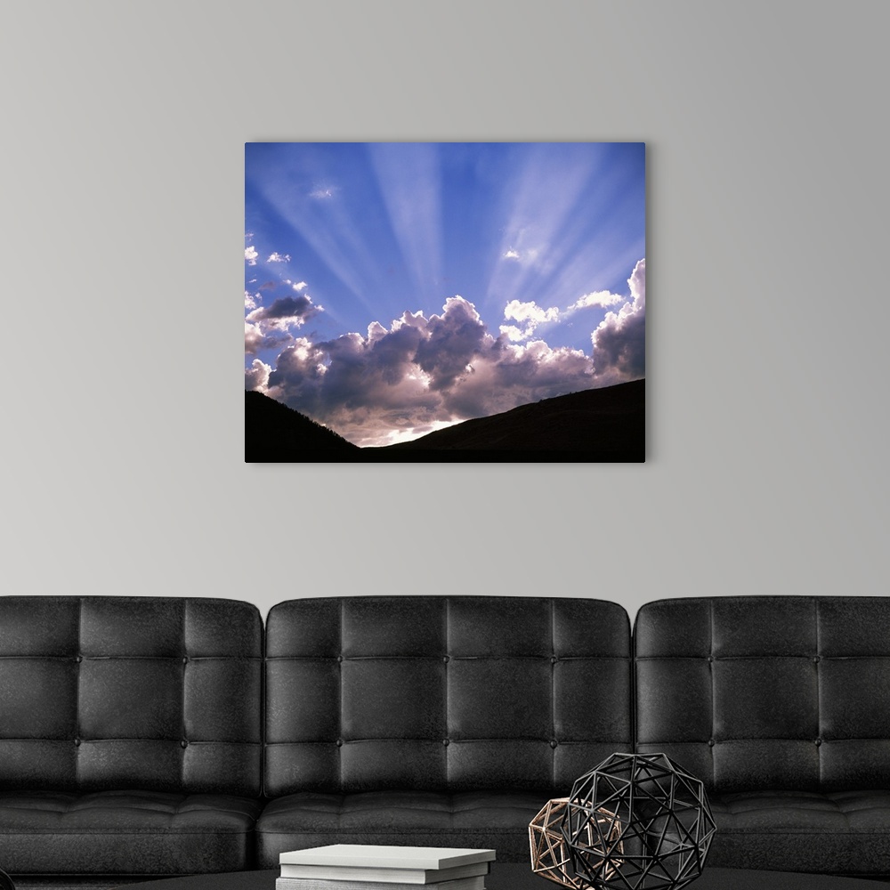 A modern room featuring Sun rays peaking from behind clouds