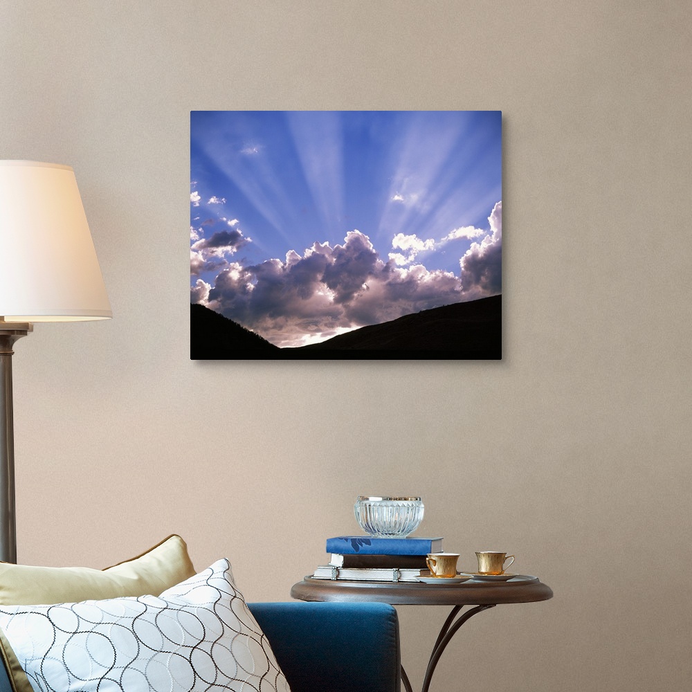 A traditional room featuring Sun rays peaking from behind clouds