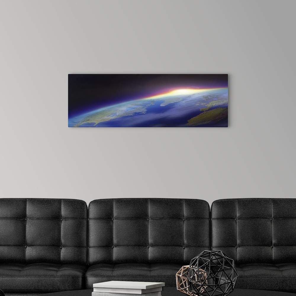 A modern room featuring Big panoramic photo from space of the sun beginning to rise over planet Earth. Land mass of the U...