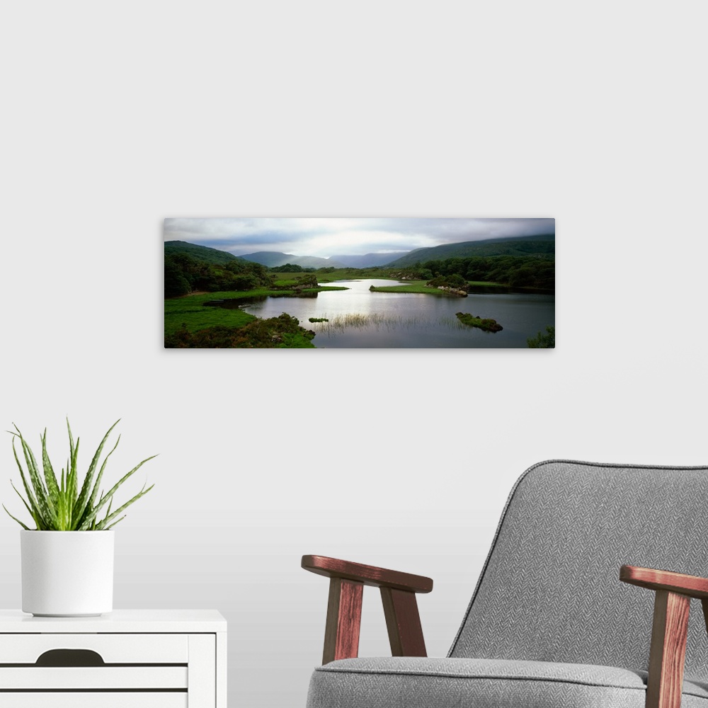 A modern room featuring Sunlight on water, distant mountains in mist, Ireland