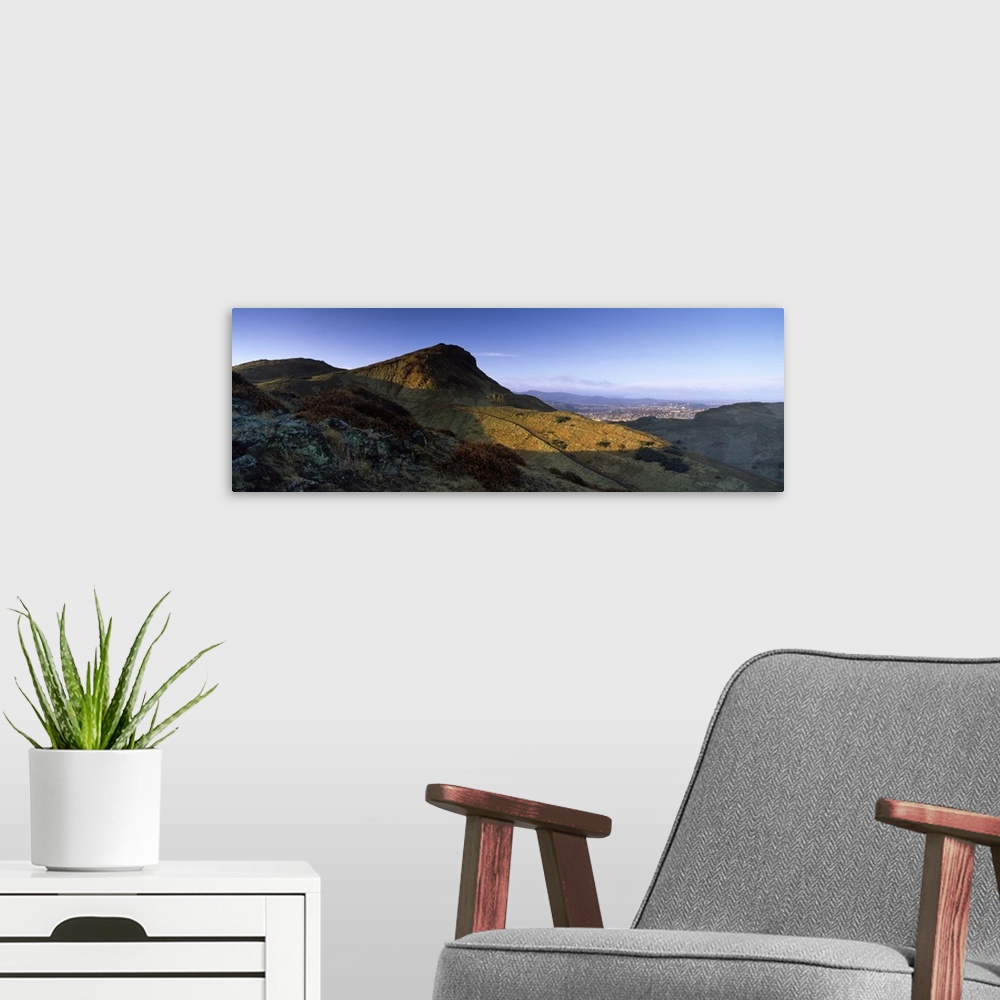A modern room featuring Sunlight over a mountain peak Arthurs Seat Edinburgh Scotland