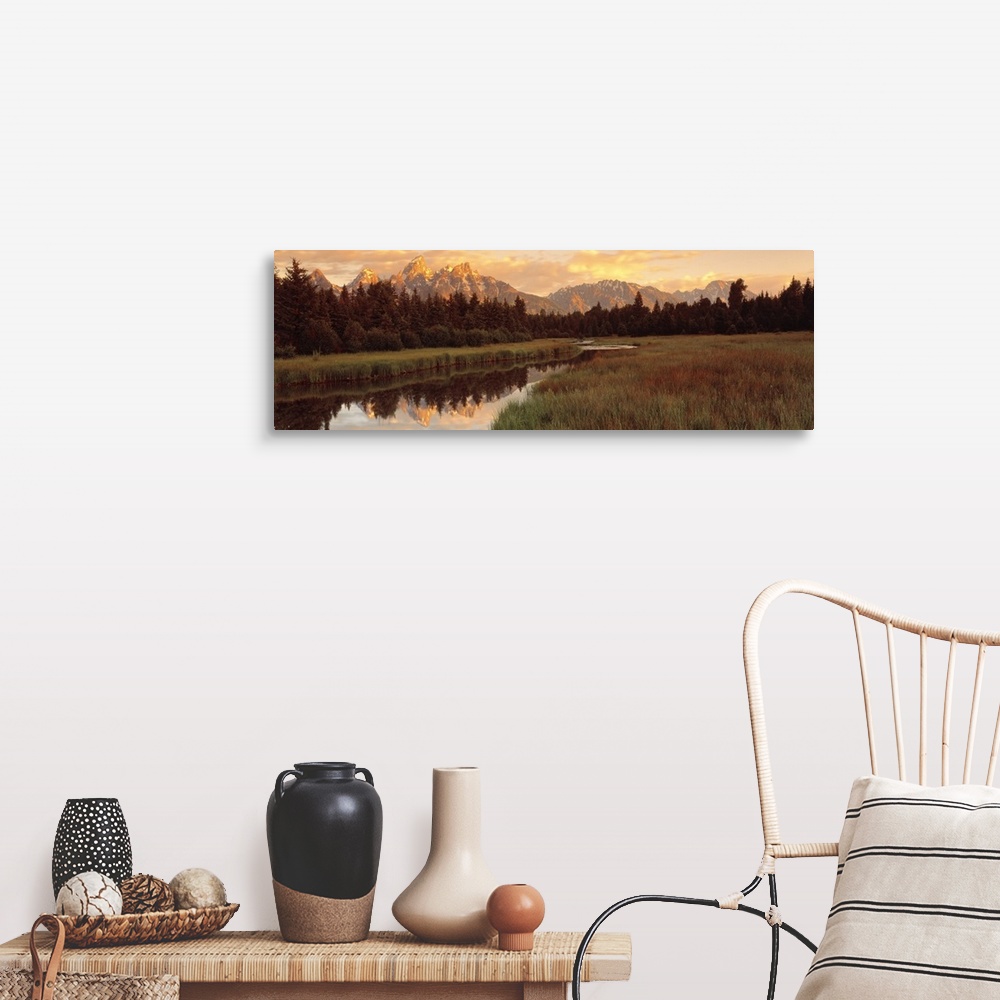 A farmhouse room featuring Panoramic photograph shows a vast landscape filled with thick forests and a snow capped mountain ...