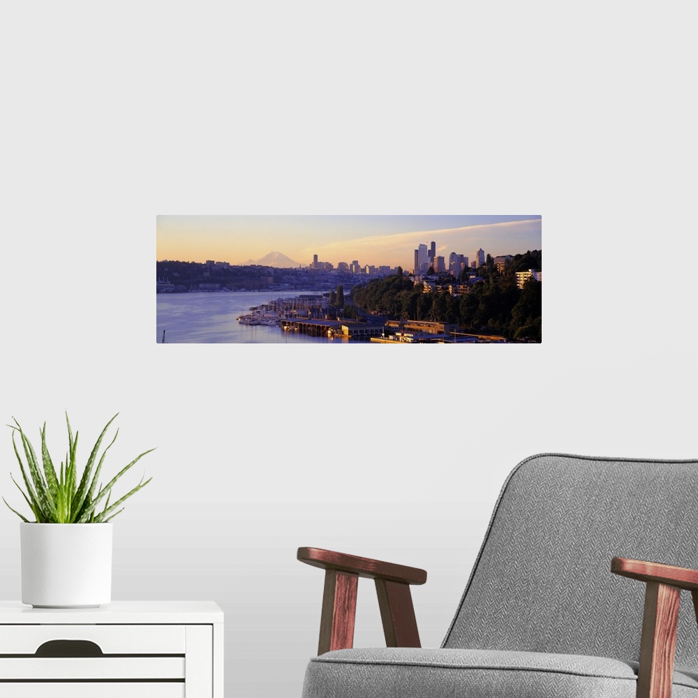 A modern room featuring Dawn on the shoreline of a harbor in a Northwestern city, with the faint image Mount Rainier in t...