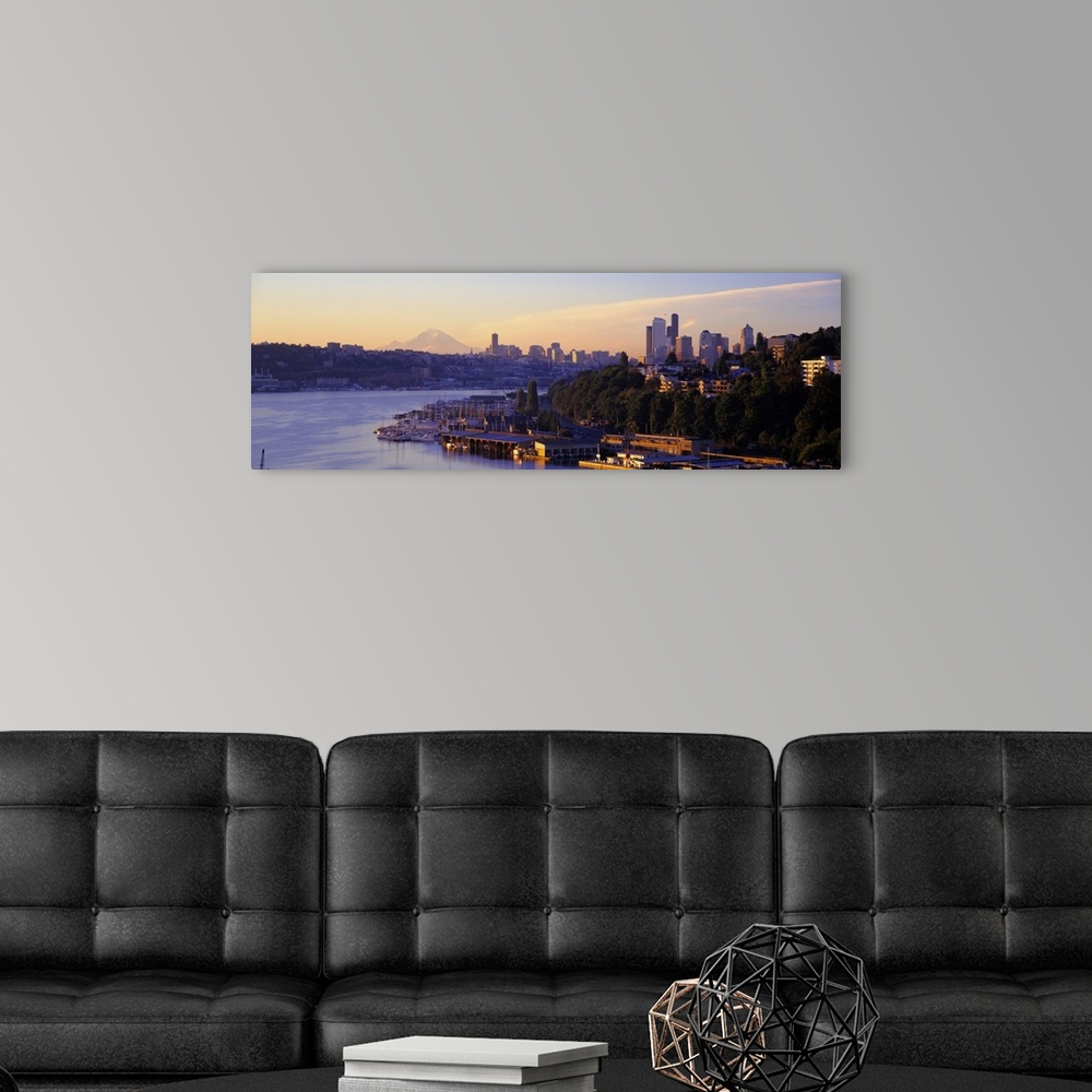 A modern room featuring Dawn on the shoreline of a harbor in a Northwestern city, with the faint image Mount Rainier in t...