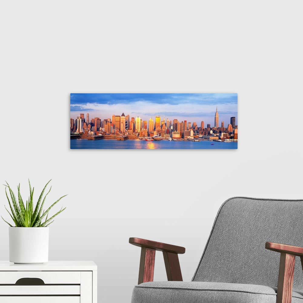 A modern room featuring Panoramic photograph taken of the sun as it begins to shine over the New York skyline filled with...