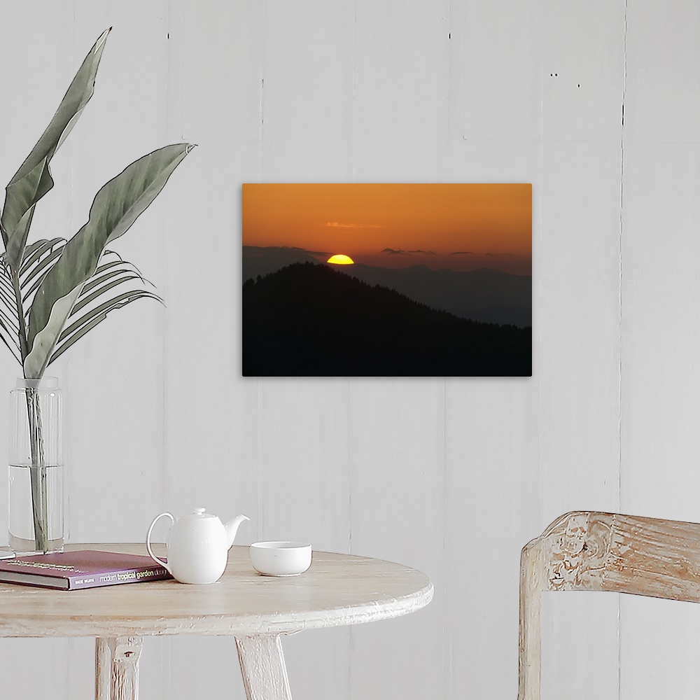 A farmhouse room featuring This landscape photograph captures the sun rising above the silhouettes of Appalachian mountains.