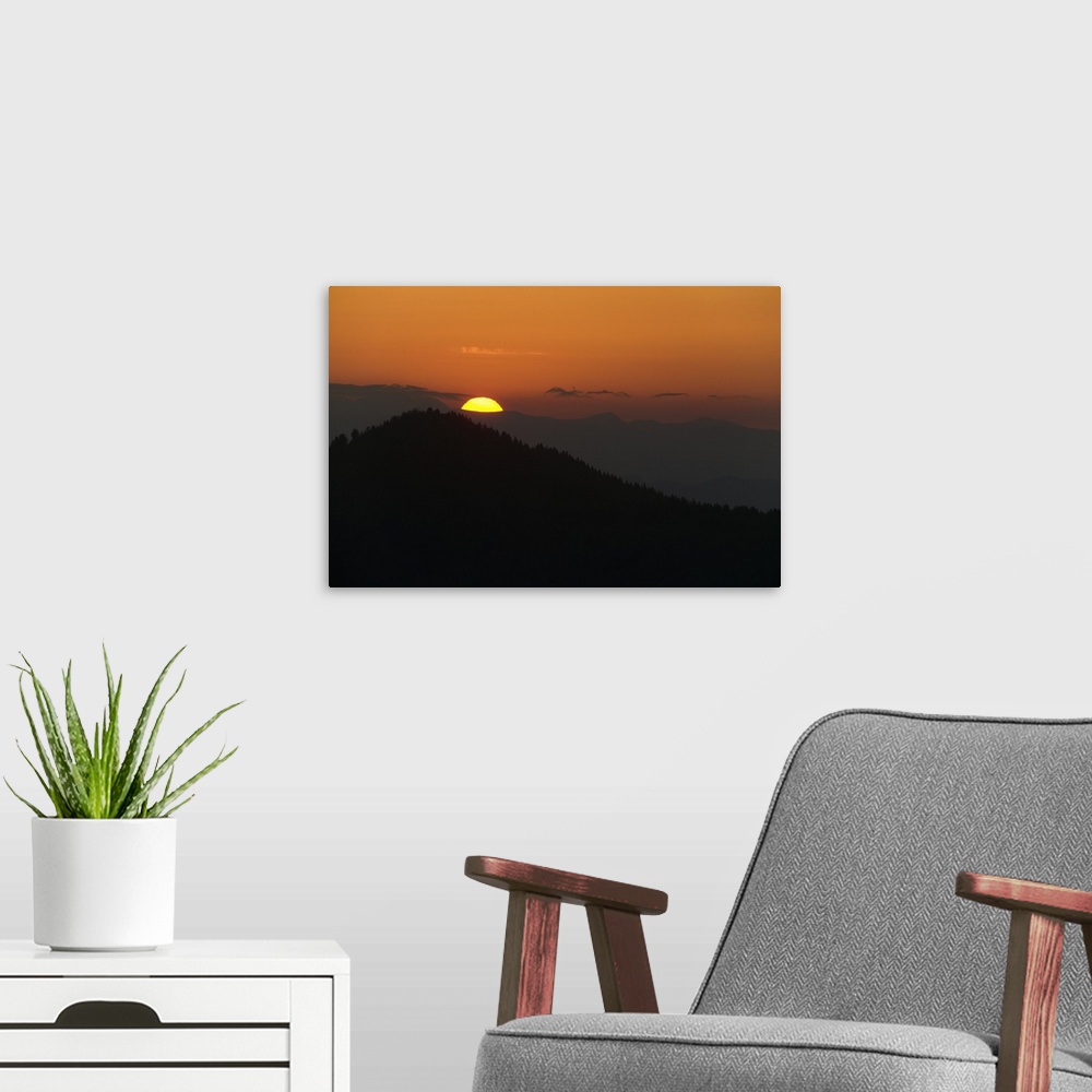 A modern room featuring This landscape photograph captures the sun rising above the silhouettes of Appalachian mountains.