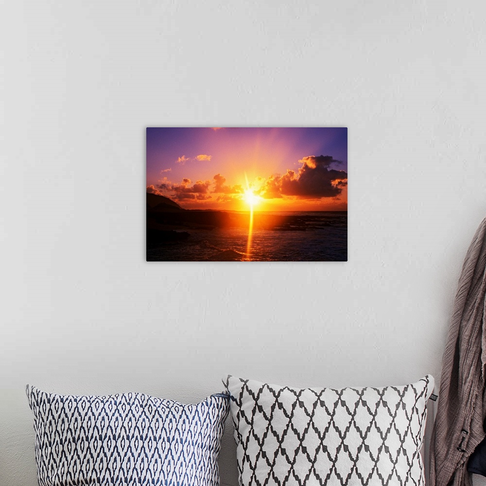 A bohemian room featuring Giant photograph shows a sunrise over Sandy Beach Park in Oahu, Hawaii.  The brightness of the su...
