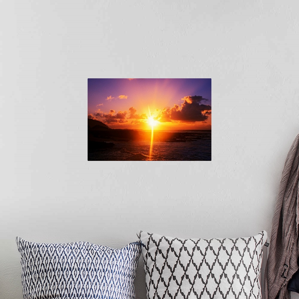 A bohemian room featuring Giant photograph shows a sunrise over Sandy Beach Park in Oahu, Hawaii.  The brightness of the su...
