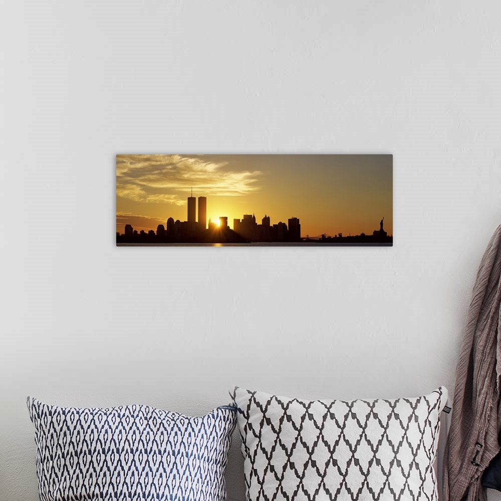A bohemian room featuring Panoramic photo of the sun rising right between two buildings in the silhouetted New York skyline...