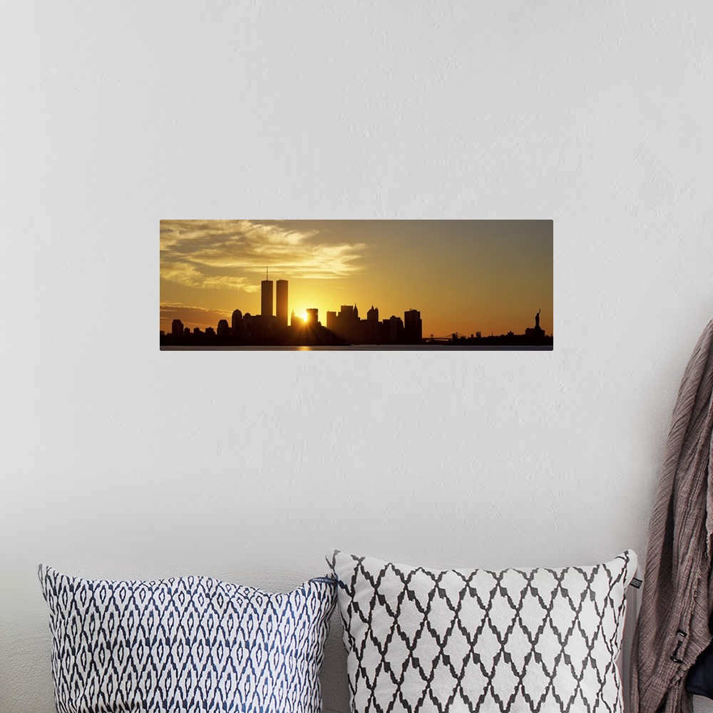 A bohemian room featuring Panoramic photo of the sun rising right between two buildings in the silhouetted New York skyline...