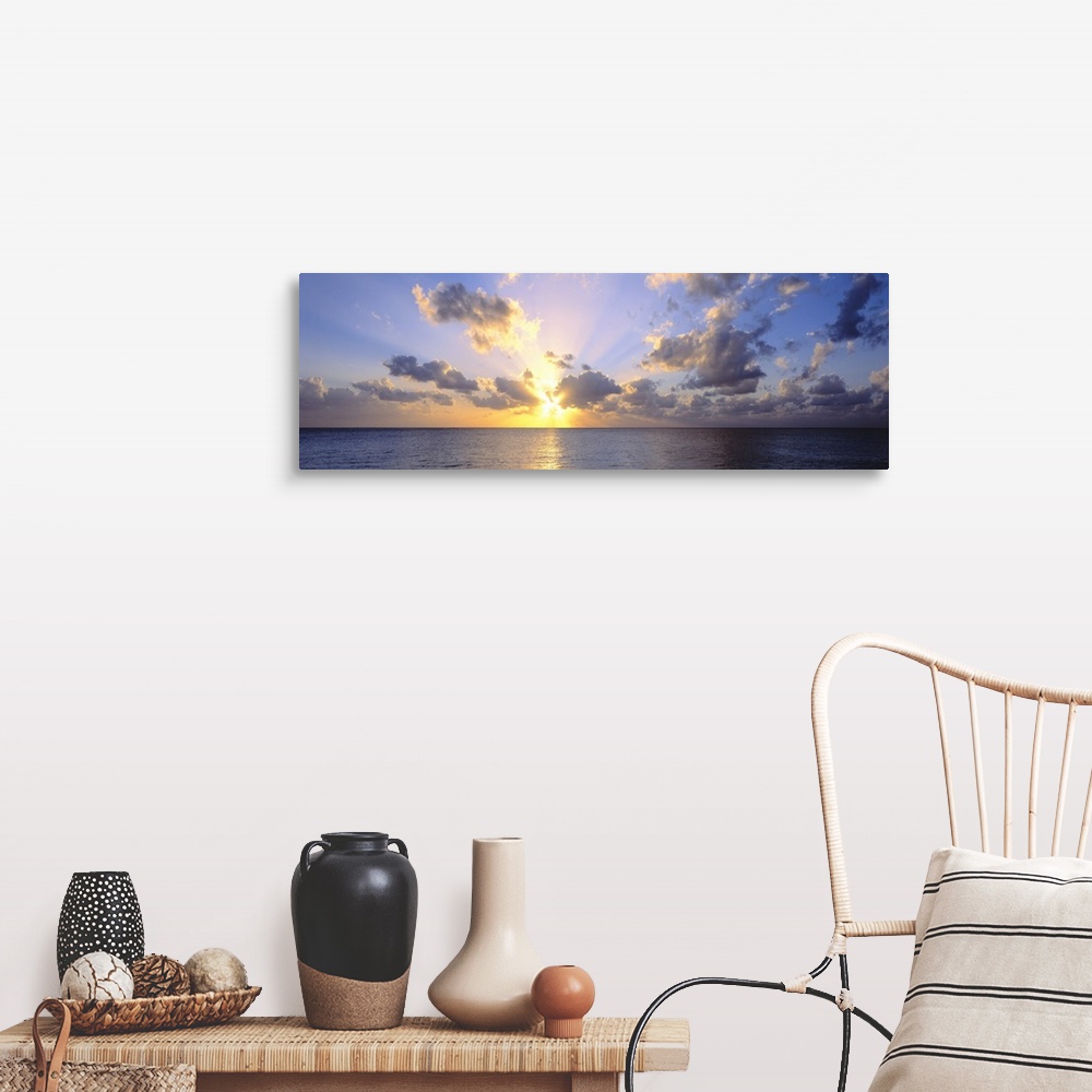 A farmhouse room featuring Giant panoramic photograph of the sun about to set in the distance from the perspective of a beac...