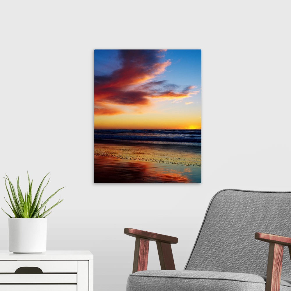 A modern room featuring Photograph of a cloudy beach sunset with gently rolling waves in the distant