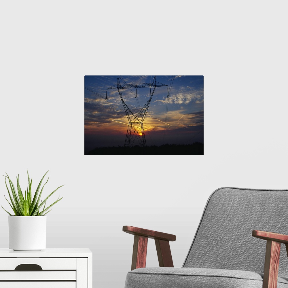 A modern room featuring Sunset behind high tension power lines.