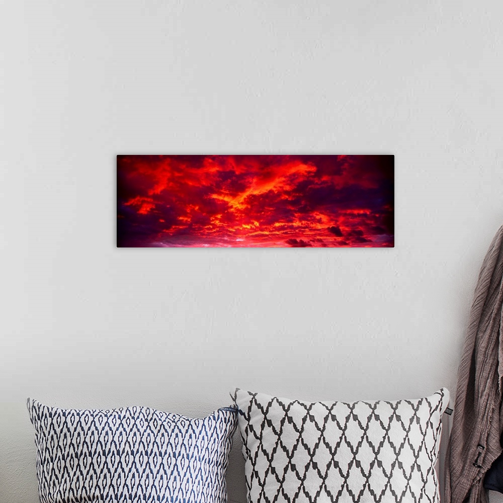 A bohemian room featuring Panoramic image of low level clouds in the sky reflecting the brilliant colors of the sunset to w...