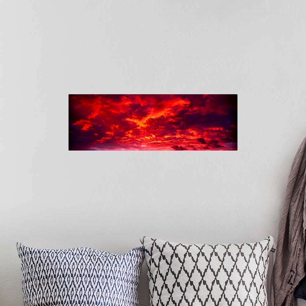 A bohemian room featuring Panoramic image of low level clouds in the sky reflecting the brilliant colors of the sunset to w...
