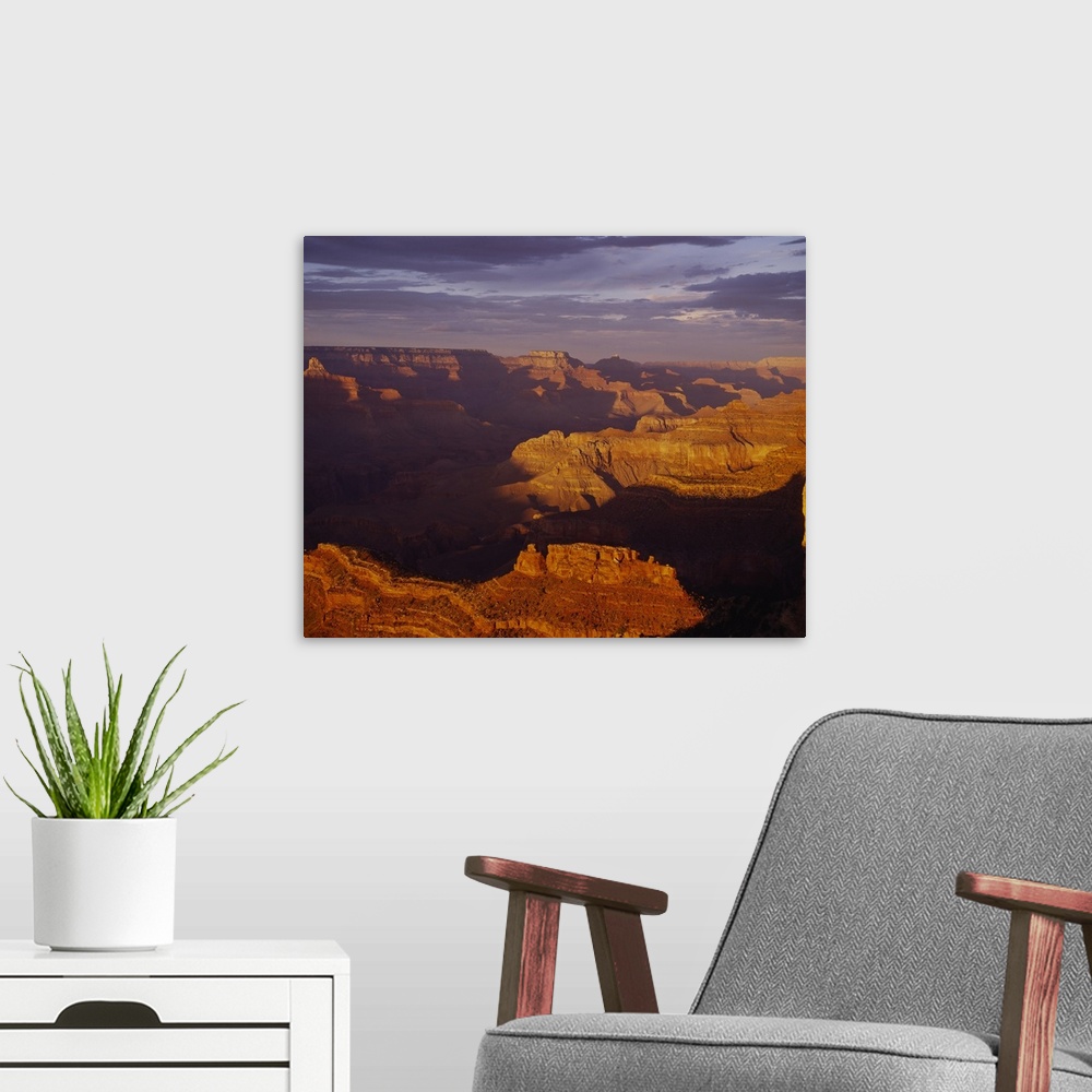 A modern room featuring Vista of an arid desert canyon with strong shadows created by the late afternoon sun in the South...