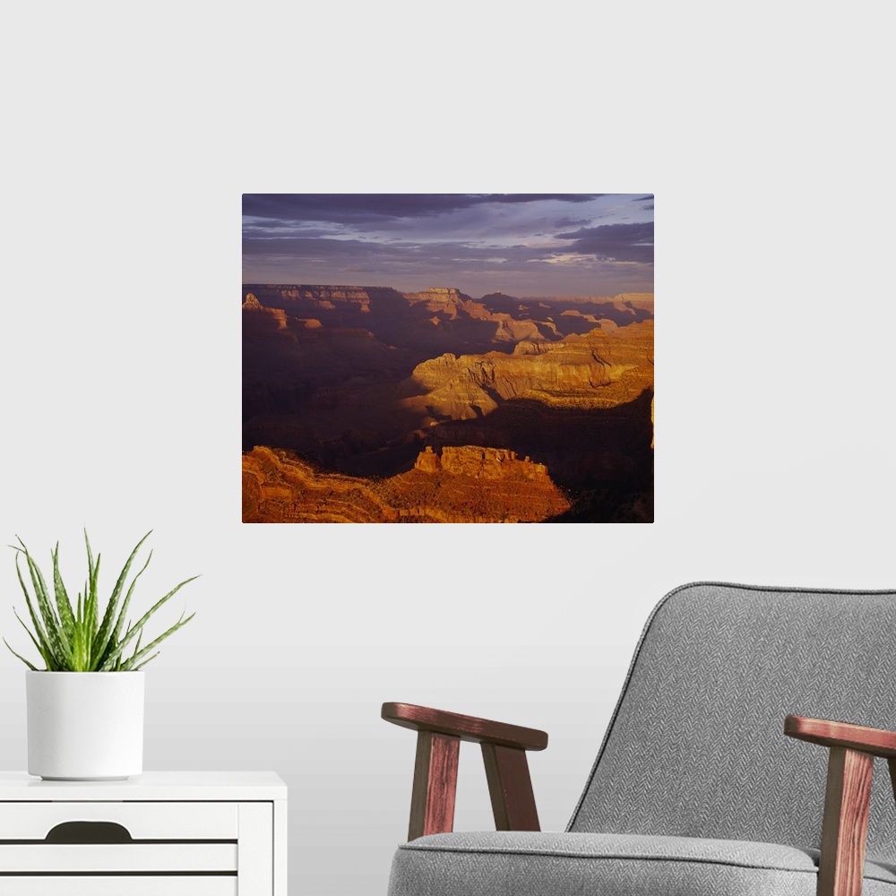 A modern room featuring Vista of an arid desert canyon with strong shadows created by the late afternoon sun in the South...