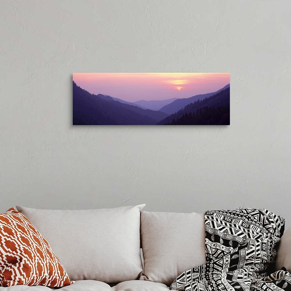 A bohemian room featuring Panoramic photo of rolling mountains in the fog at sunset.