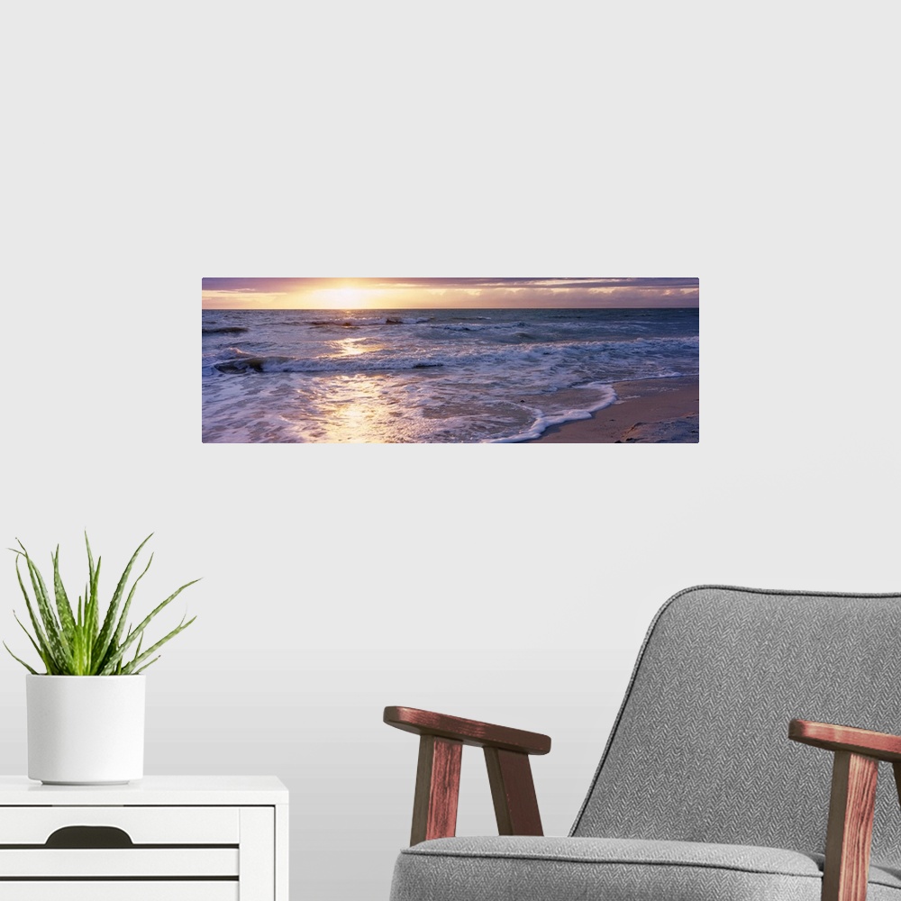 A modern room featuring Panoramic photograph of a sunset on a sandy beach in the Gulf of Mexico located within Florida.  ...