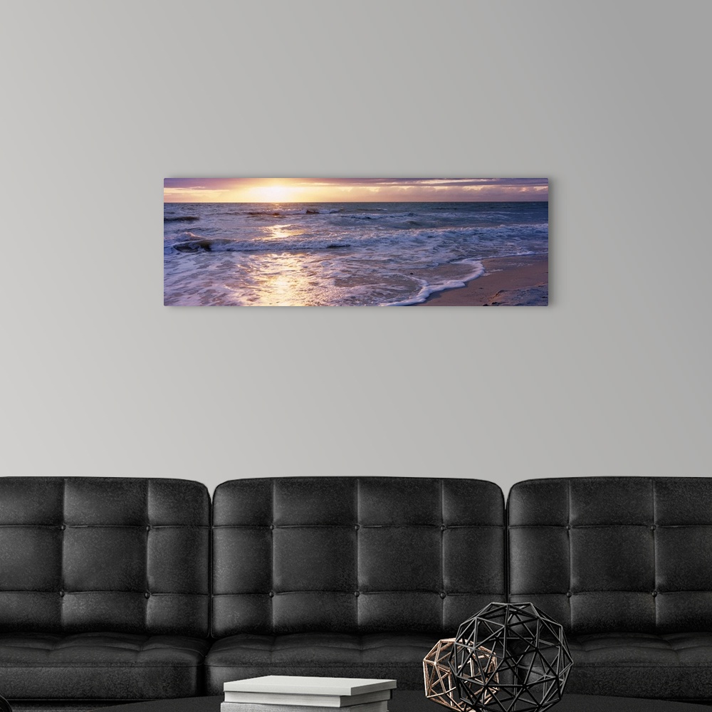A modern room featuring Panoramic photograph of a sunset on a sandy beach in the Gulf of Mexico located within Florida.  ...