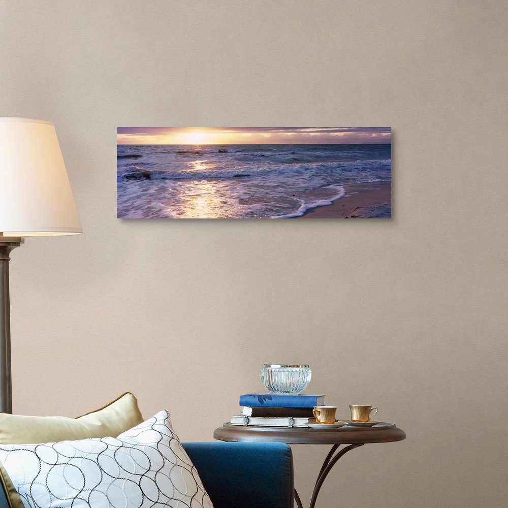 A traditional room featuring Panoramic photograph of a sunset on a sandy beach in the Gulf of Mexico located within Florida.  ...