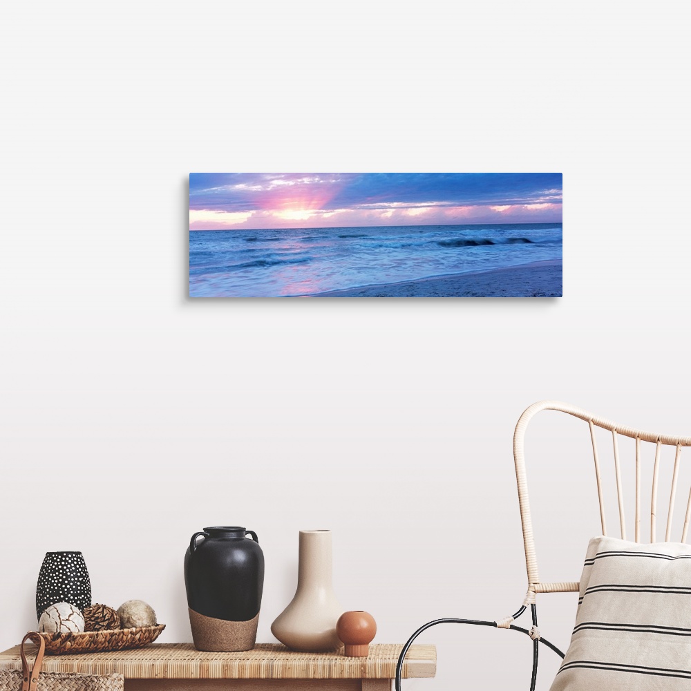 A farmhouse room featuring Large panoramic photo of the sun setting over a beach in Naples, Florida (FL).