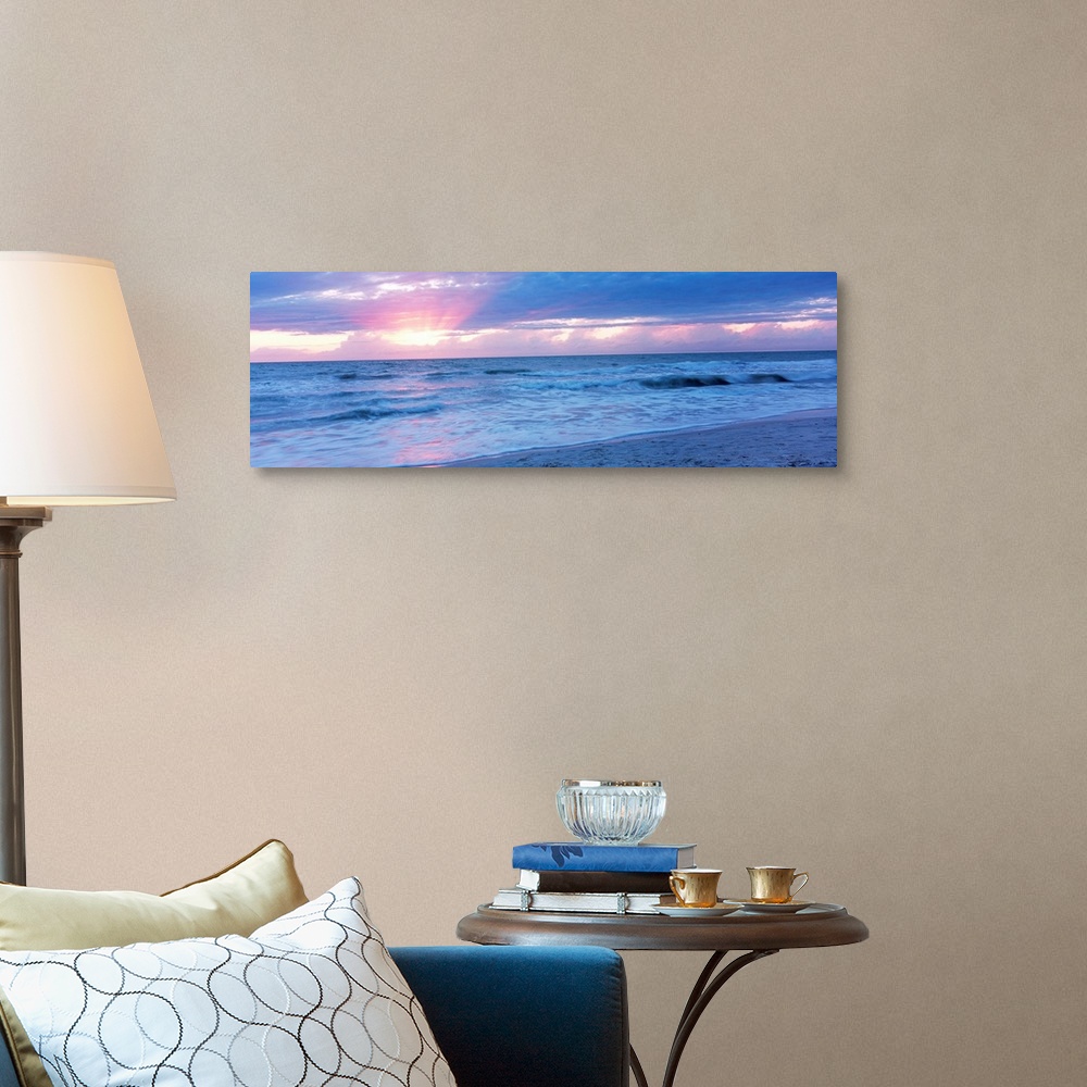 A traditional room featuring Large panoramic photo of the sun setting over a beach in Naples, Florida (FL).