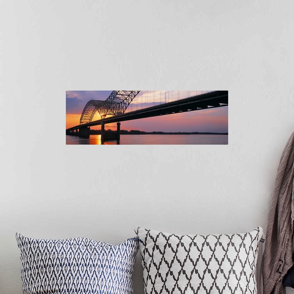 A bohemian room featuring Picture taken of the sunset through a bridge over the Mississippi river.