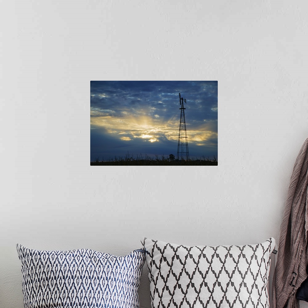 A bohemian room featuring Sunset light through heavy clouds, silhouetted windmill, Iowa
