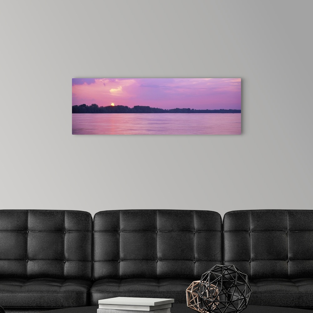A modern room featuring A pink-hued sunset panorama of the Mississippi riverbanks in Memphis, Tennessee.