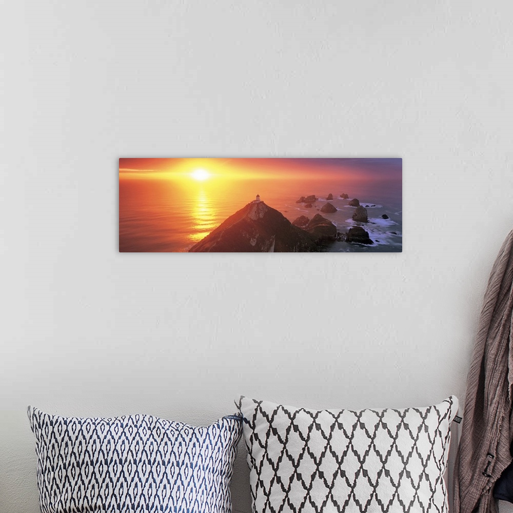 A bohemian room featuring Sunset Nugget Point Lighthouse New Zealand