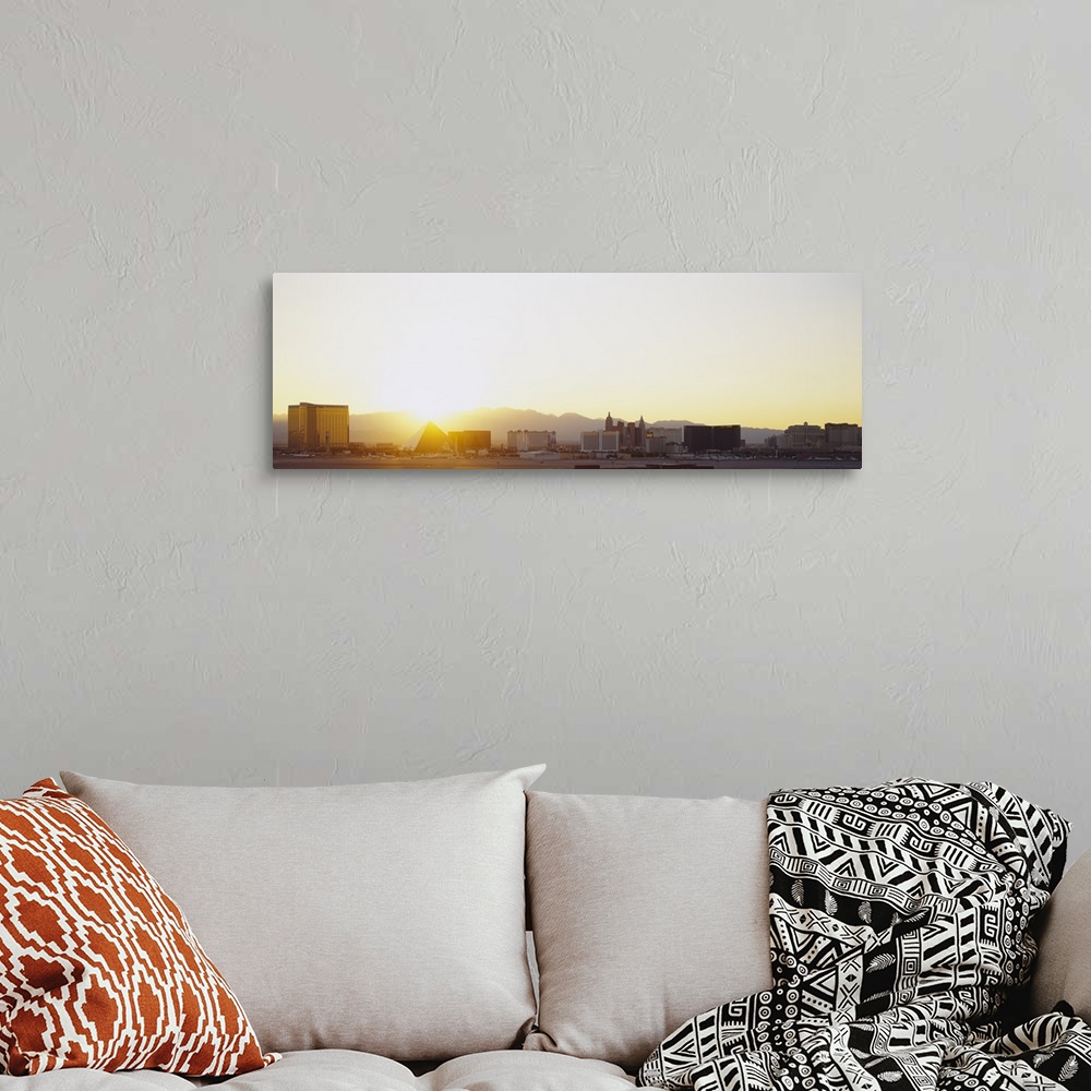 A bohemian room featuring Panoramic picture taken of the strip in Las Vegas with a bright sun setting behind the mountains ...