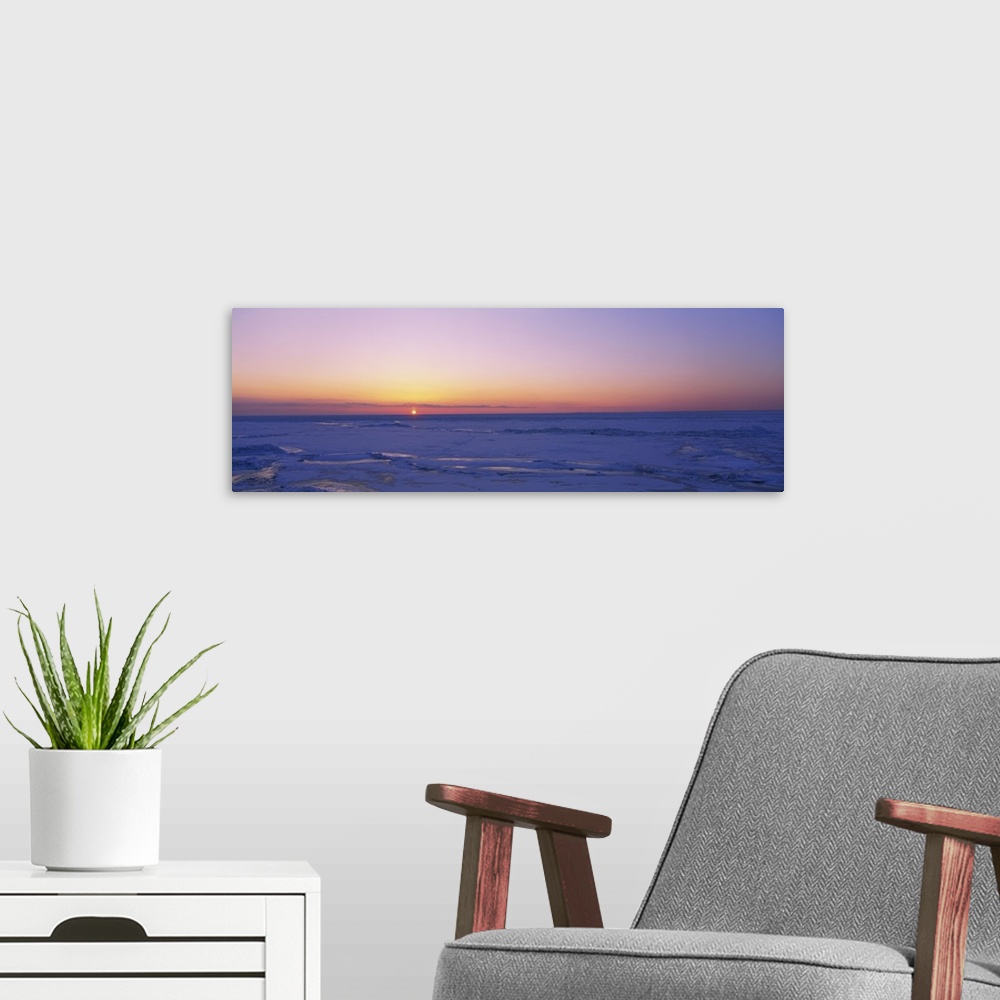 A modern room featuring Sunset over a frozen lake, Lake Erie, New York State
