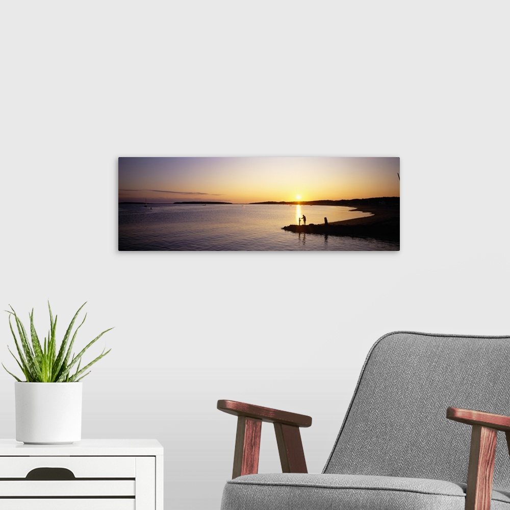 A modern room featuring Sunset over a lake